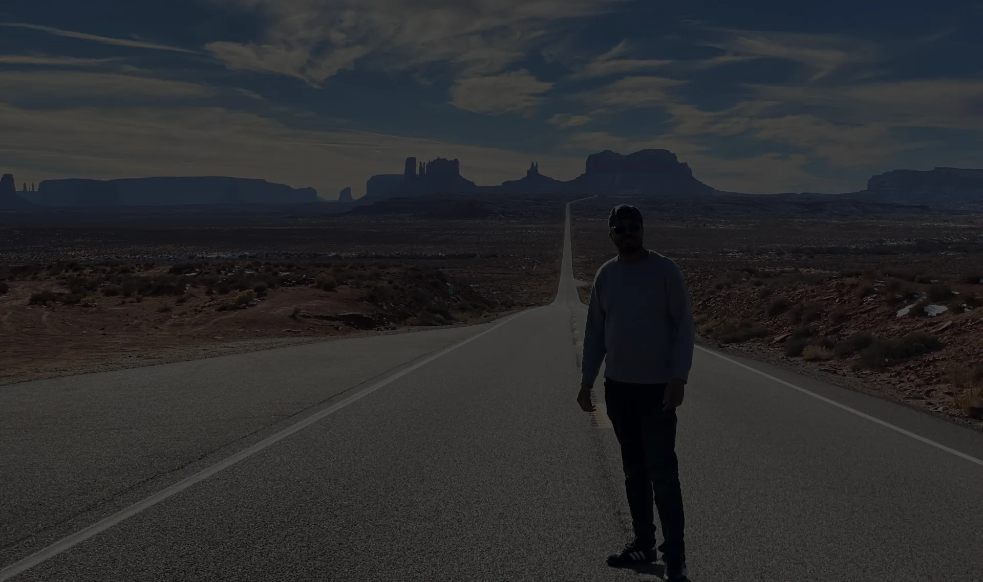 Marshall standing on the open road in Monument Valley